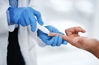 Buy stock photo Shot of an unrecognisable doctor using a blood sugar test on his patient’s finger