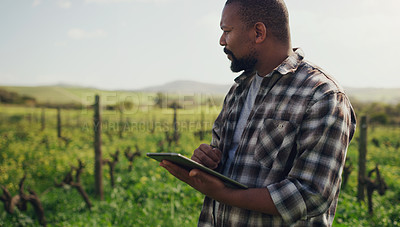 Buy stock photo Farm, tablet and a black man on a field for agriculture, sustainability or crop research during spring. Internet, innovation and a male farmer standing in the countryside for the harvest season