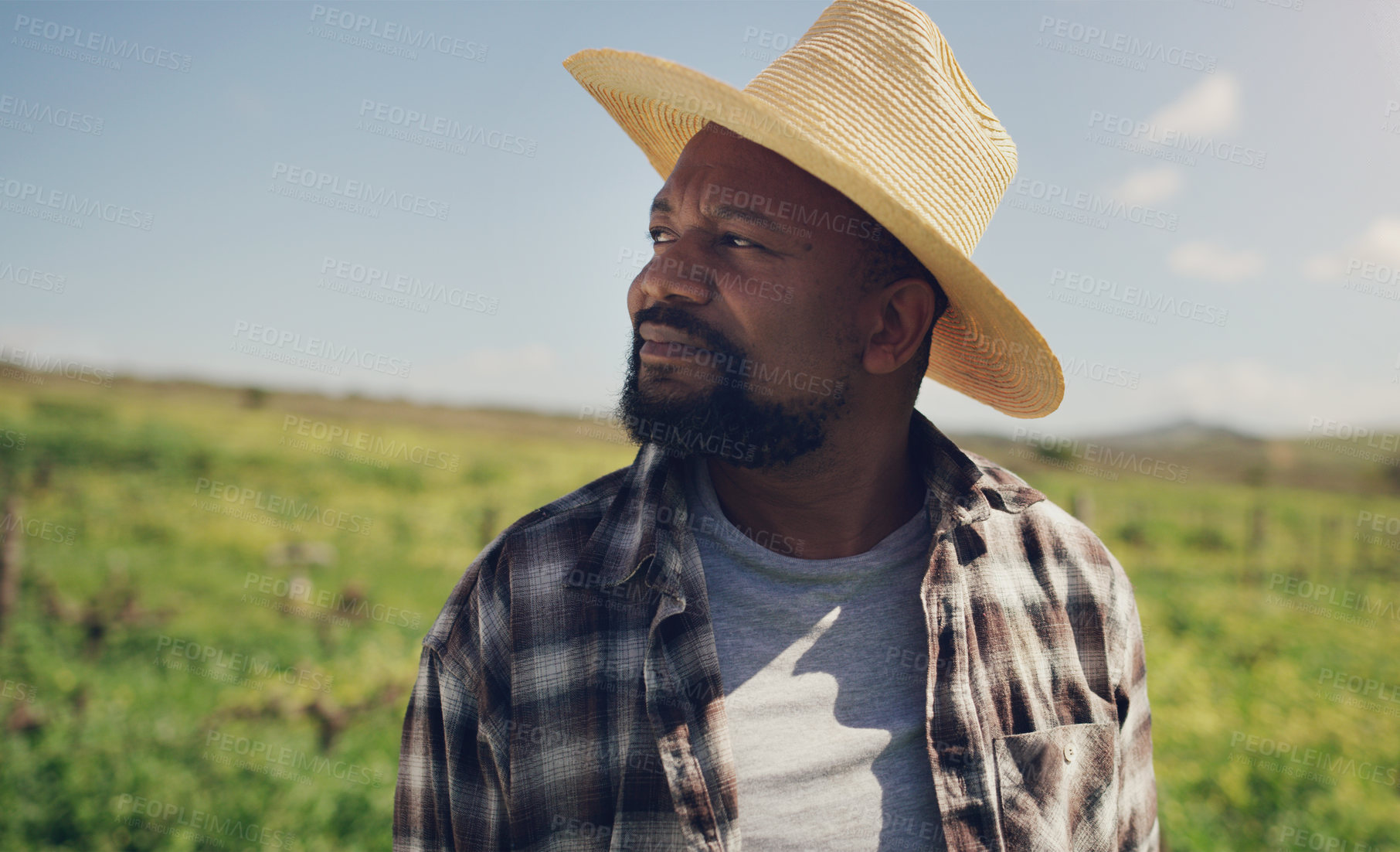 Buy stock photo Black man, farmer and thinking with hat on grass field for agriculture, sustainability or natural growth in countryside. African male person in wonder or thought for eco friendly environment on farm