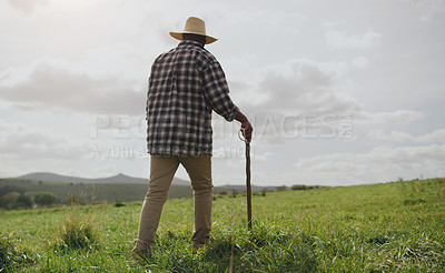 Buy stock photo Rearview shot of a man working on a farm