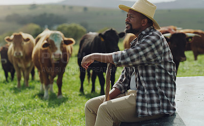 Buy stock photo Shot of a mature man working on a cow farm