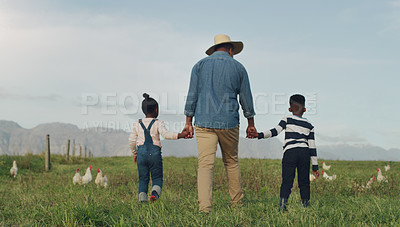 Buy stock photo Family, holding hands and a dad walking on a farm with his children for agriculture or sustainability. Back, farming an a father with his kids in the meadow as a cow farmer in the natural countryside