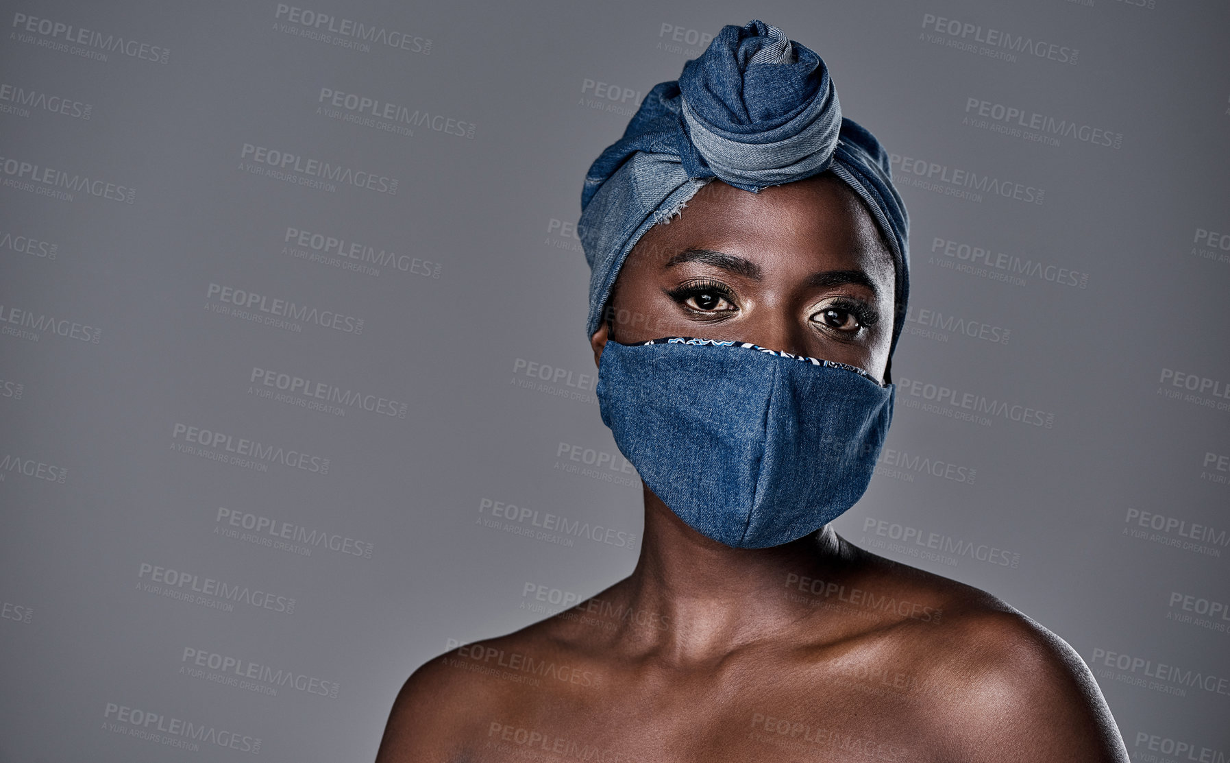 Buy stock photo Shot of a beautiful young woman wearing a denim head wrap and mask