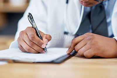 Buy stock photo Closeup shot of an unrecognisable doctor writing notes on a clipboard in an office