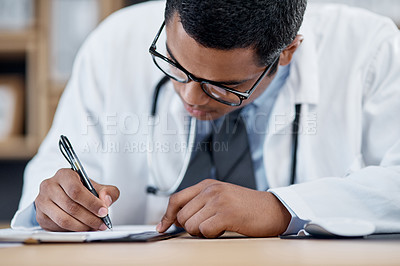 Buy stock photo Doctor writing a prescription, survey or medical care paperwork for a patient at the hospital. A healthcare professional writing a patient information chart. A GP filing a document in an office