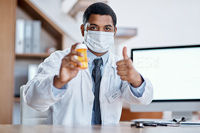 Buy stock photo Trustworthy doctor selling good covid medicine or bottle of pills, approving successful medication in hospital. Male healthcare or medical professional wearing mask, showing thumbs up hand gesture.