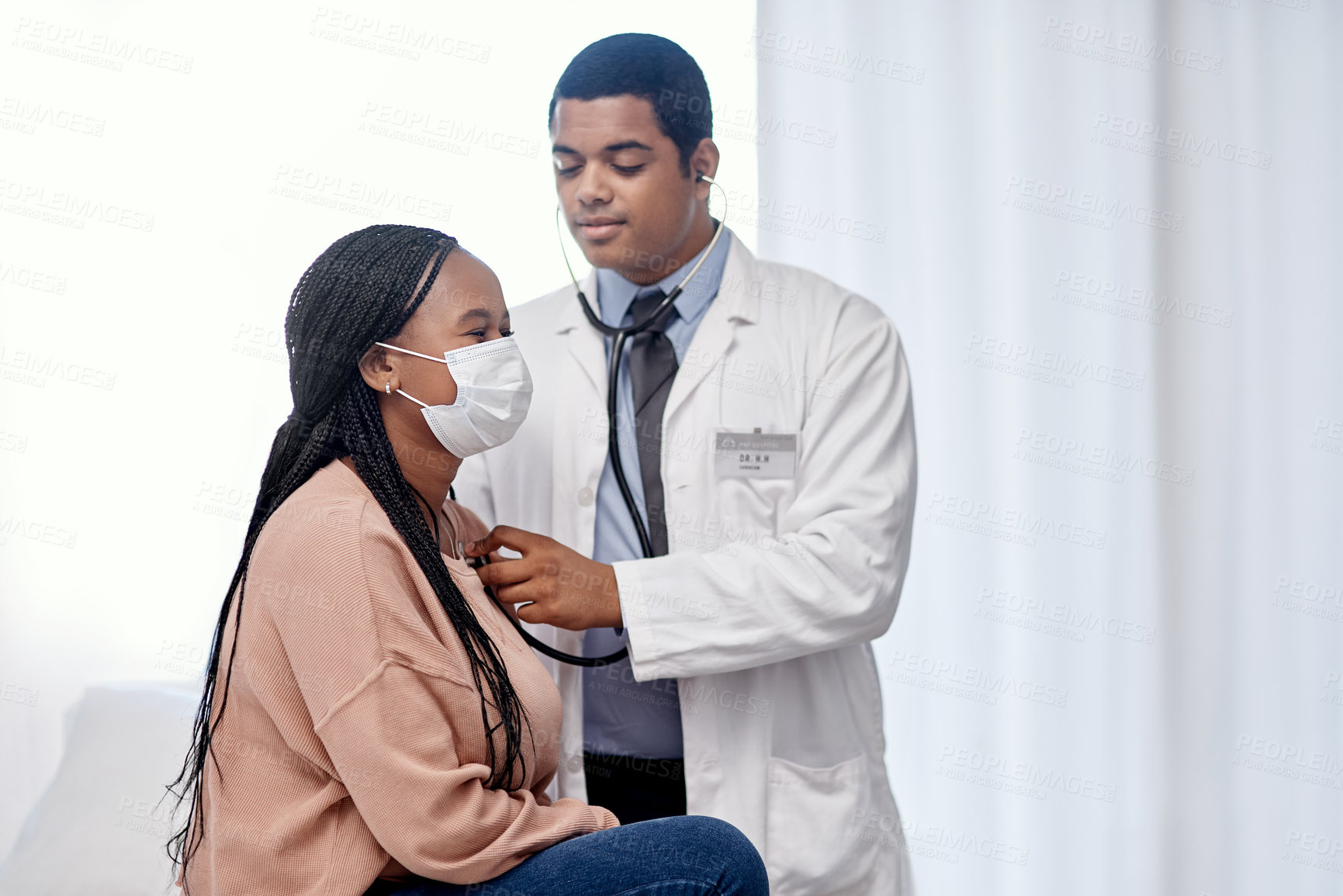 Buy stock photo Shot of a doctor examining a patient with a stethoscope