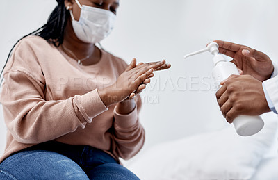 Buy stock photo Closeup shot of an unrecognisable doctor giving hand sanitiser to a patient