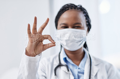 Buy stock photo Portrait of a young doctor making an okay sign