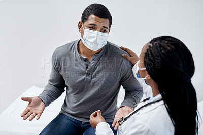 Buy stock photo Shot of a young man having a consultation with a doctor