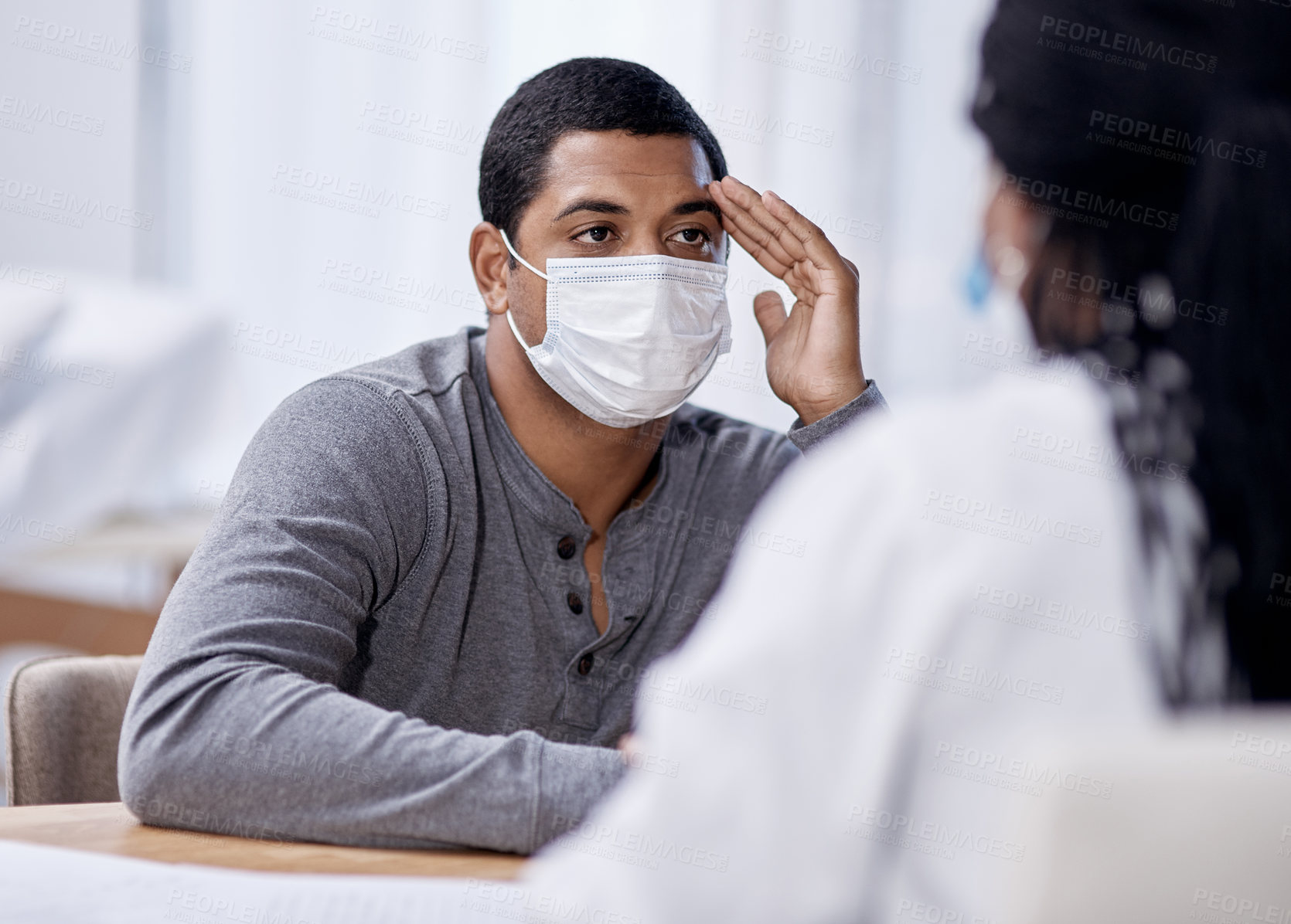 Buy stock photo Shot of a young man having a consultation with a doctor