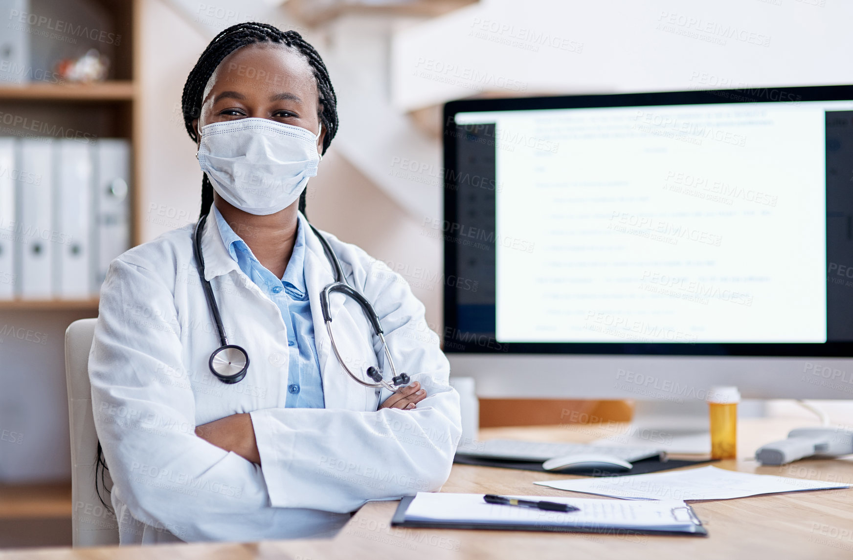 Buy stock photo Portrait of a young doctor wearing a face mask while working in her office