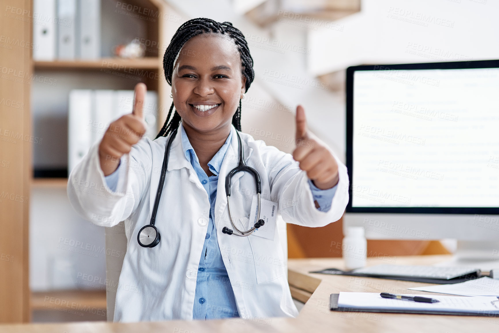 Buy stock photo Portrait of a young doctor showing thumbs up in her office