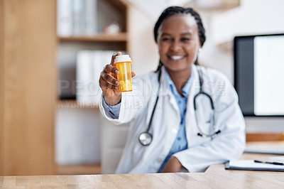 Buy stock photo Portrait of a young doctor holding a bottle of pills in her office