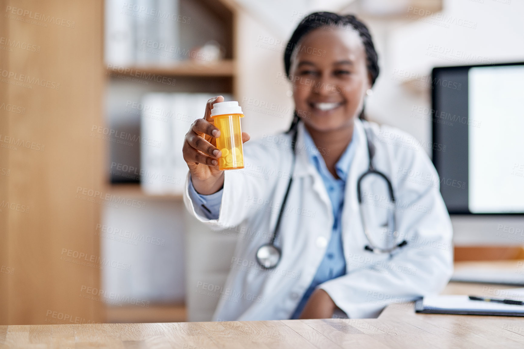 Buy stock photo Portrait of a young doctor holding a bottle of pills in her office
