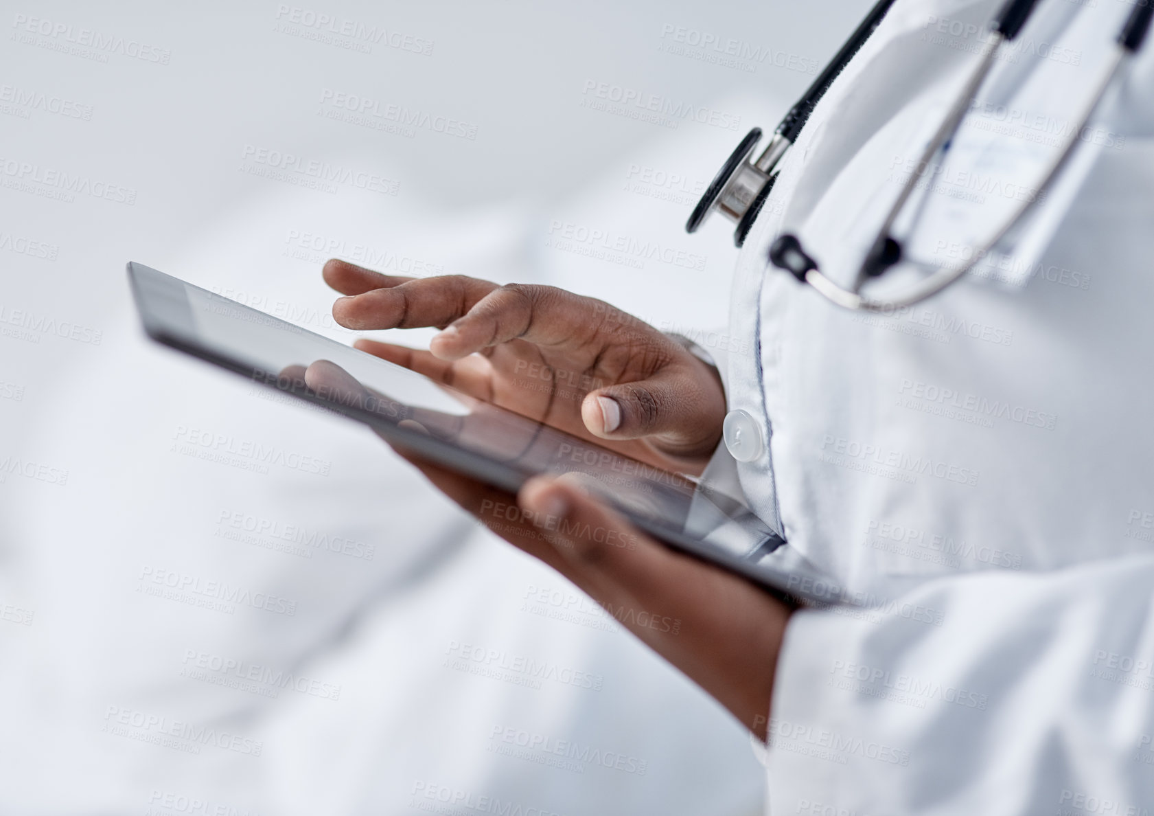 Buy stock photo Closeup shot of an unrecognisable doctor using a digital tablet in a hospital