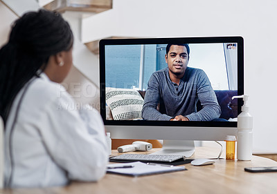 Buy stock photo Shot of a young man having a video call with a doctor on a computer