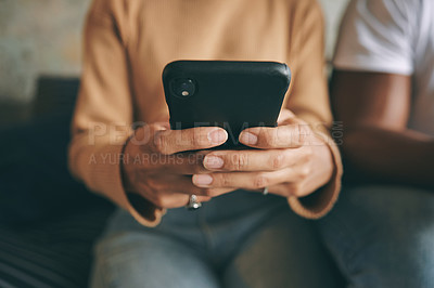 Buy stock photo Closeup shot of an unrecognisable woman using a cellphone at home