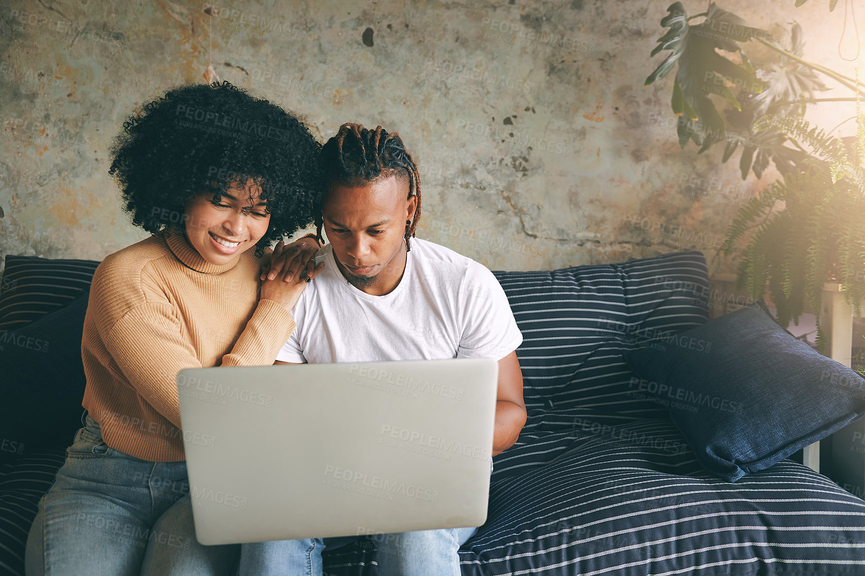 Buy stock photo Laptop, reading and couple on sofa in home for reservation of romantic weekend with online hotel checkin. Love, relax and African man with woman on computer for booking honeymoon vacation in house.