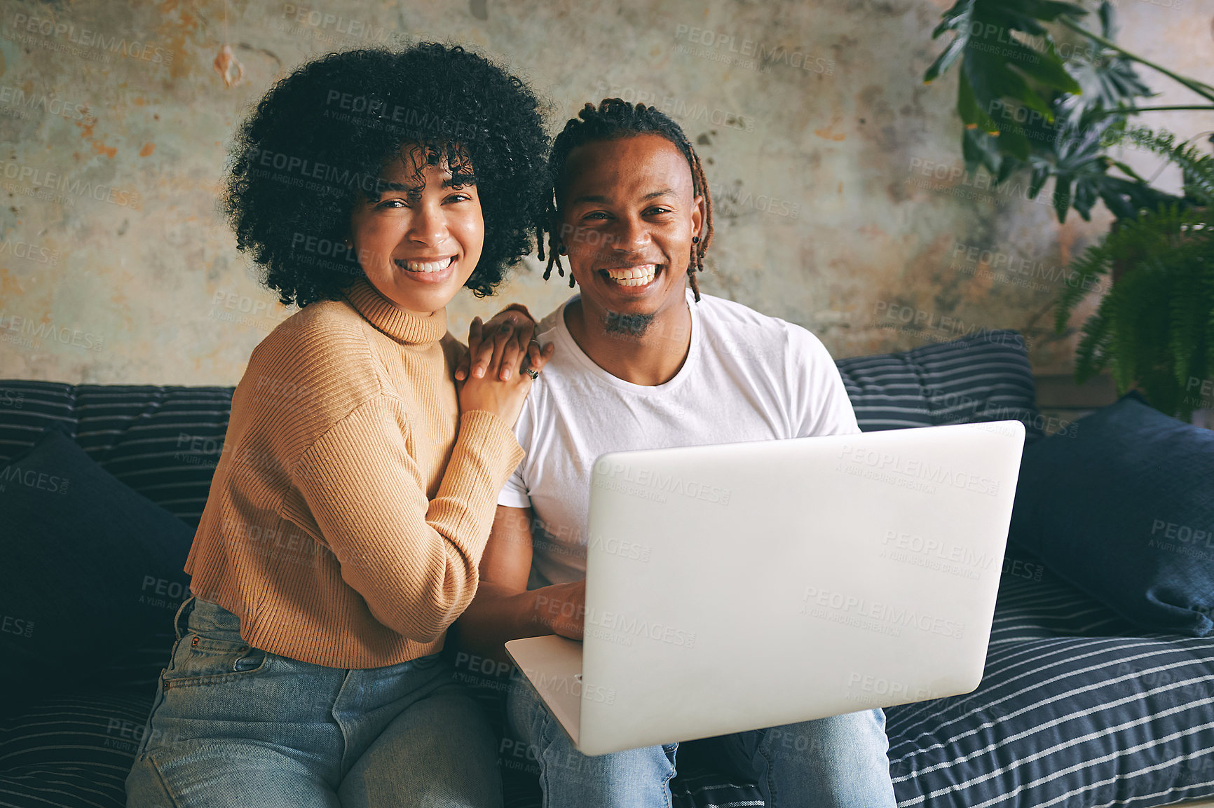 Buy stock photo Portrait of a young couple using a laptop together at home