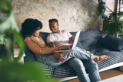 Buy stock photo Shot of a young couple using a laptop together at home