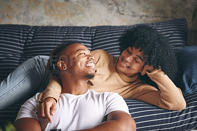 Buy stock photo Shot of a young couple relaxing together at home