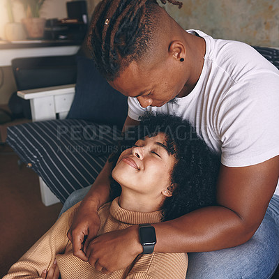 Buy stock photo Shot of a young couple relaxing together at home