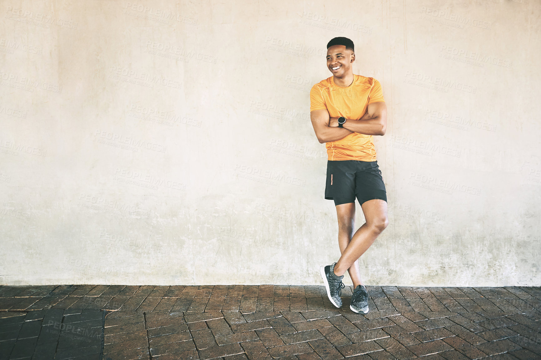 Buy stock photo Shot of a confident young man having a workout against an urban background