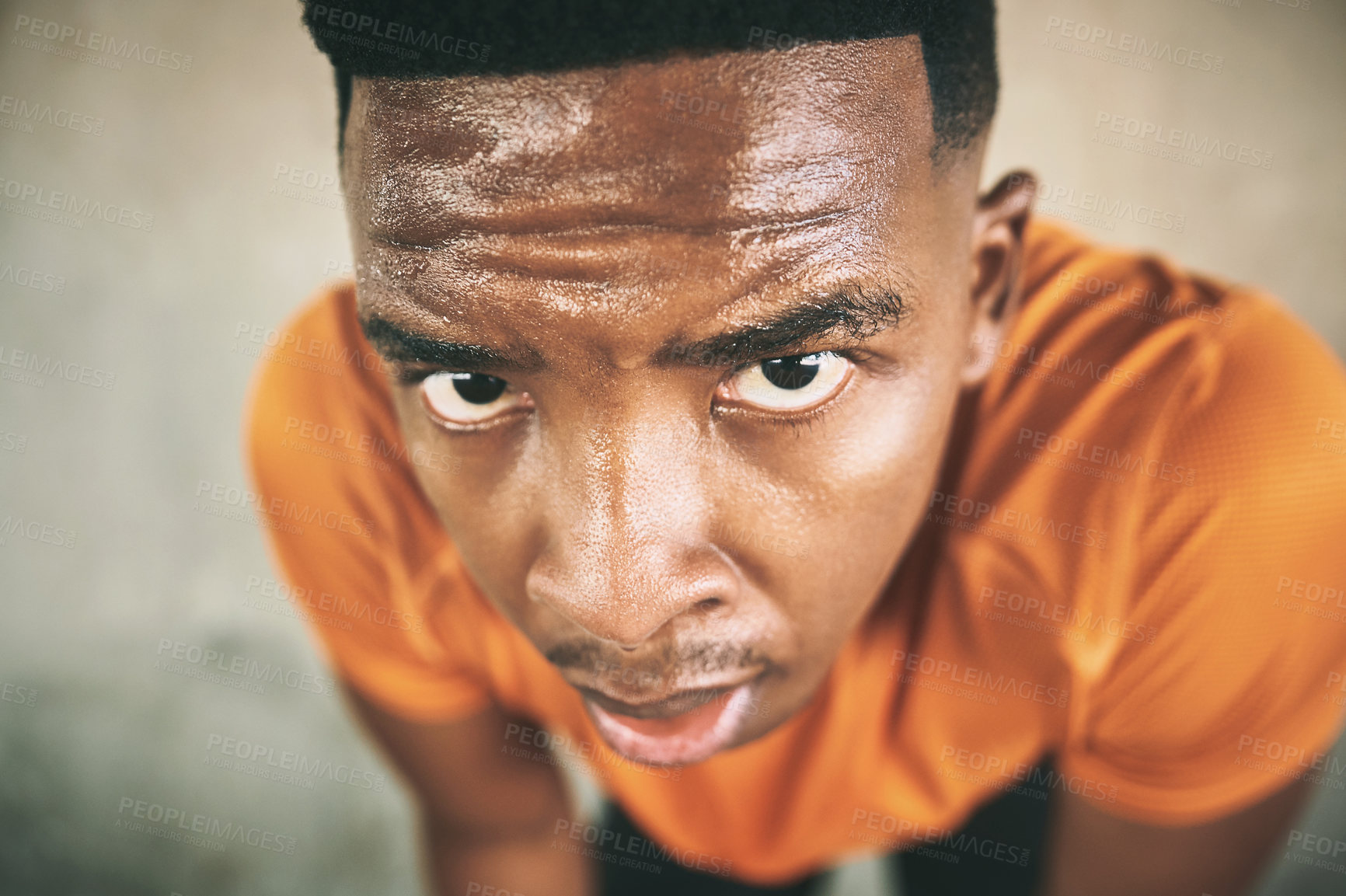 Buy stock photo Shot of a young man taking a break after working out against an urban background