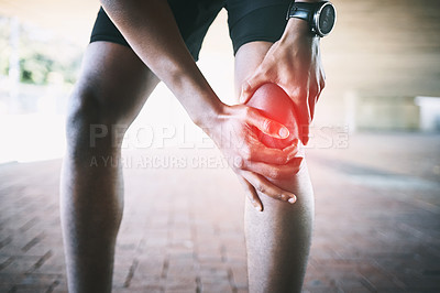 Buy stock photo Cropped shot of a man experiencing joint pain while working out against an urban background