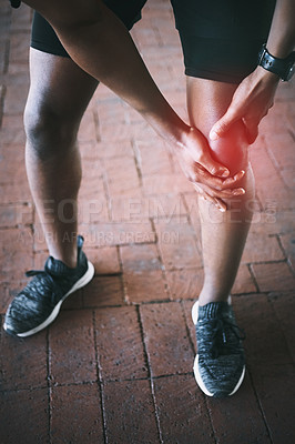 Buy stock photo Cropped shot of a man experiencing joint pain while working out against an urban background