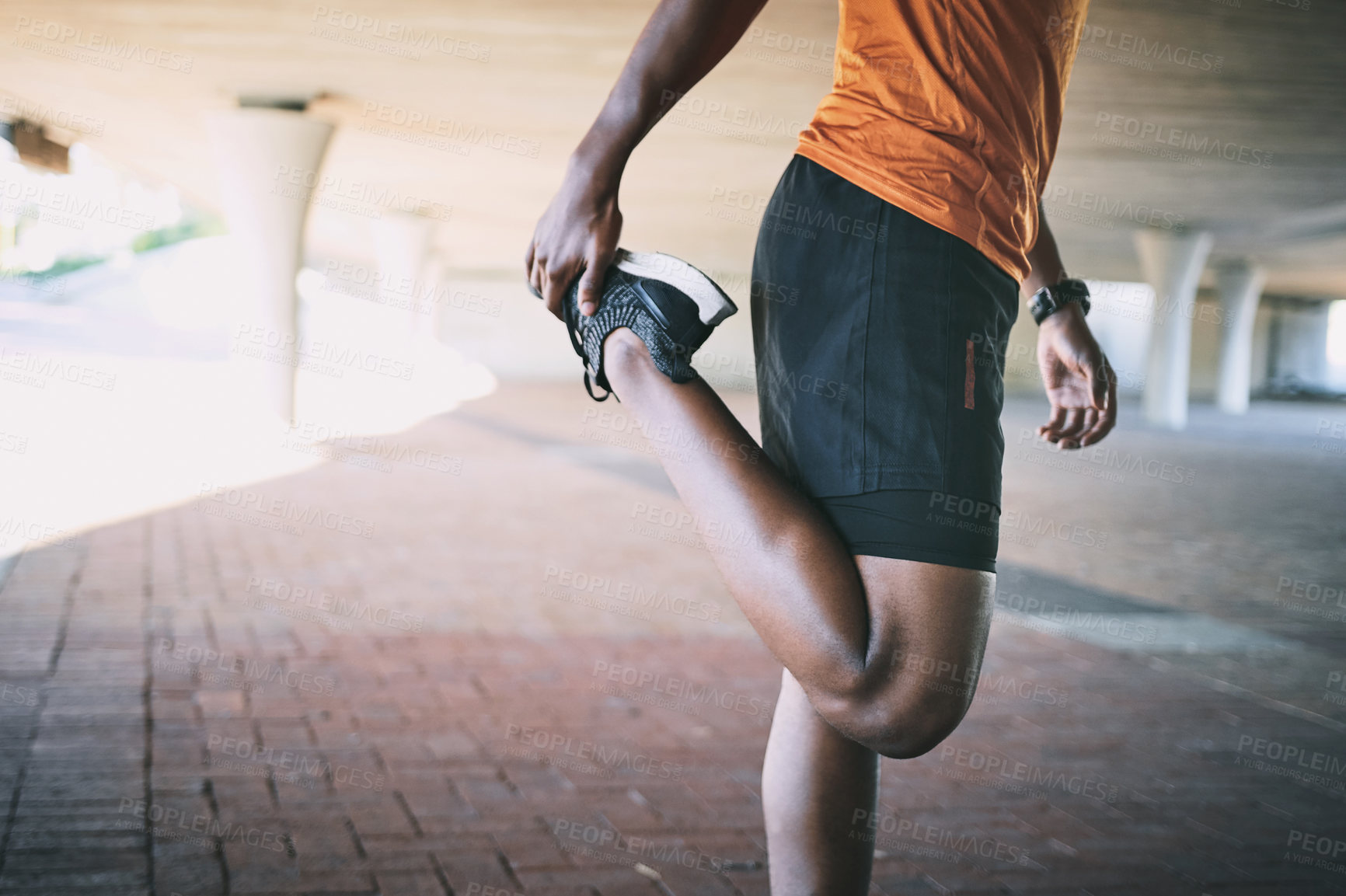 Buy stock photo Cropped shot of a man stretching during a workout against an urban background