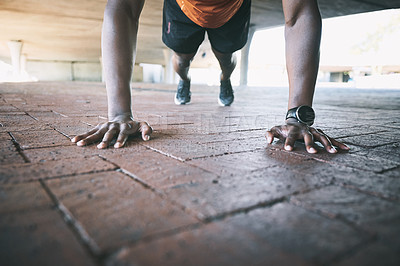 Buy stock photo Cropped shot of a man doing pushups against an urban background