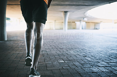 Buy stock photo Cropped shot of a man going for a run against an urban background