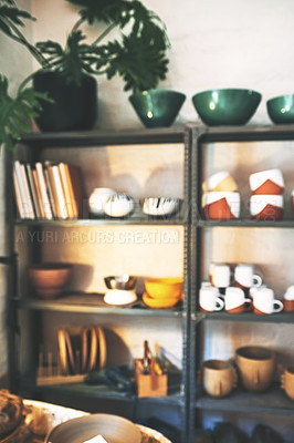Buy stock photo Shot of various pottery crafts on a shelf in an empty pottery studio during the day