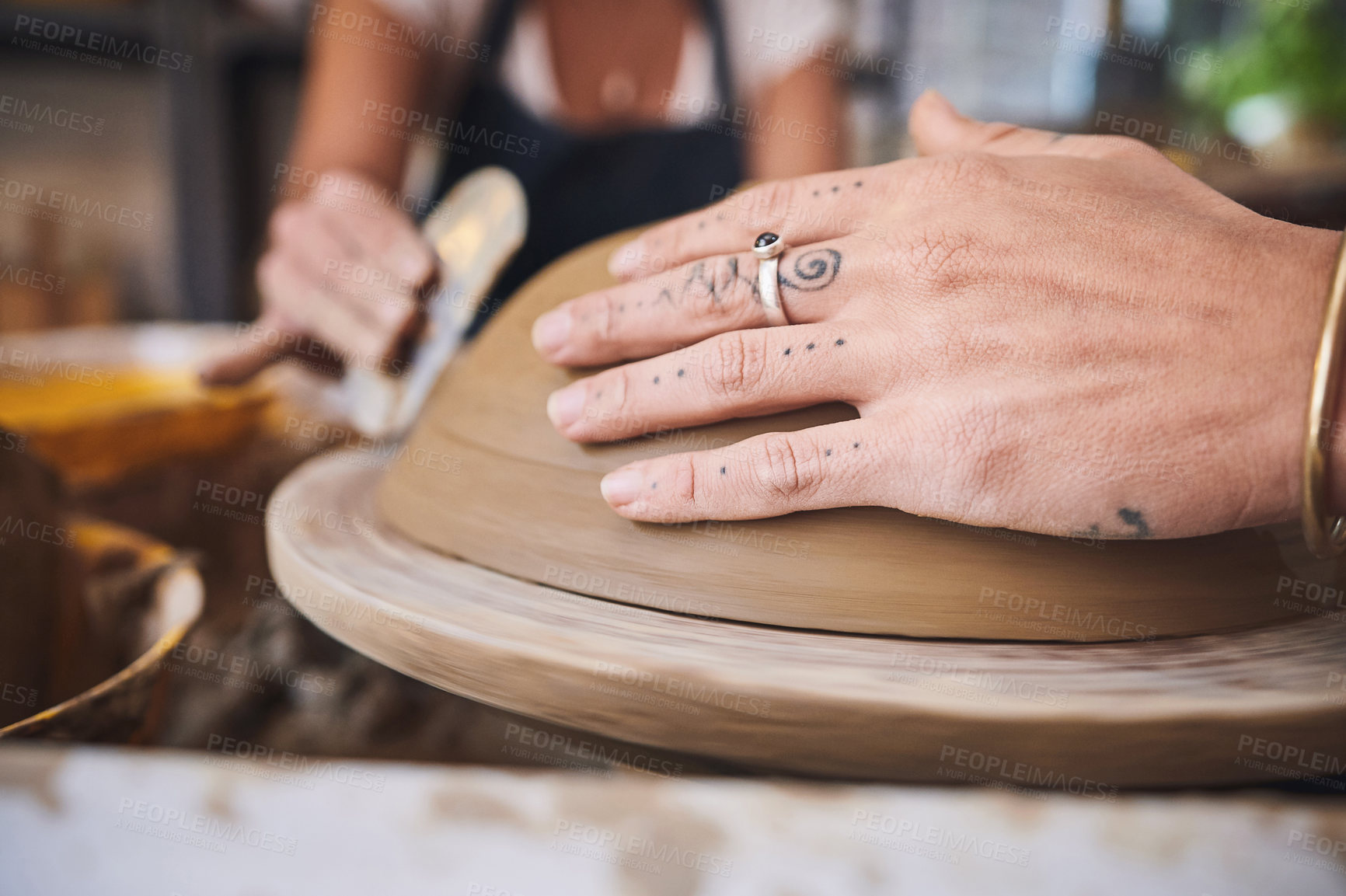 Buy stock photo Shot of an unrecognisable woman working with clay in a pottery studio