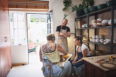 Buy stock photo Shot of a group of young people working with clay in a pottery studio