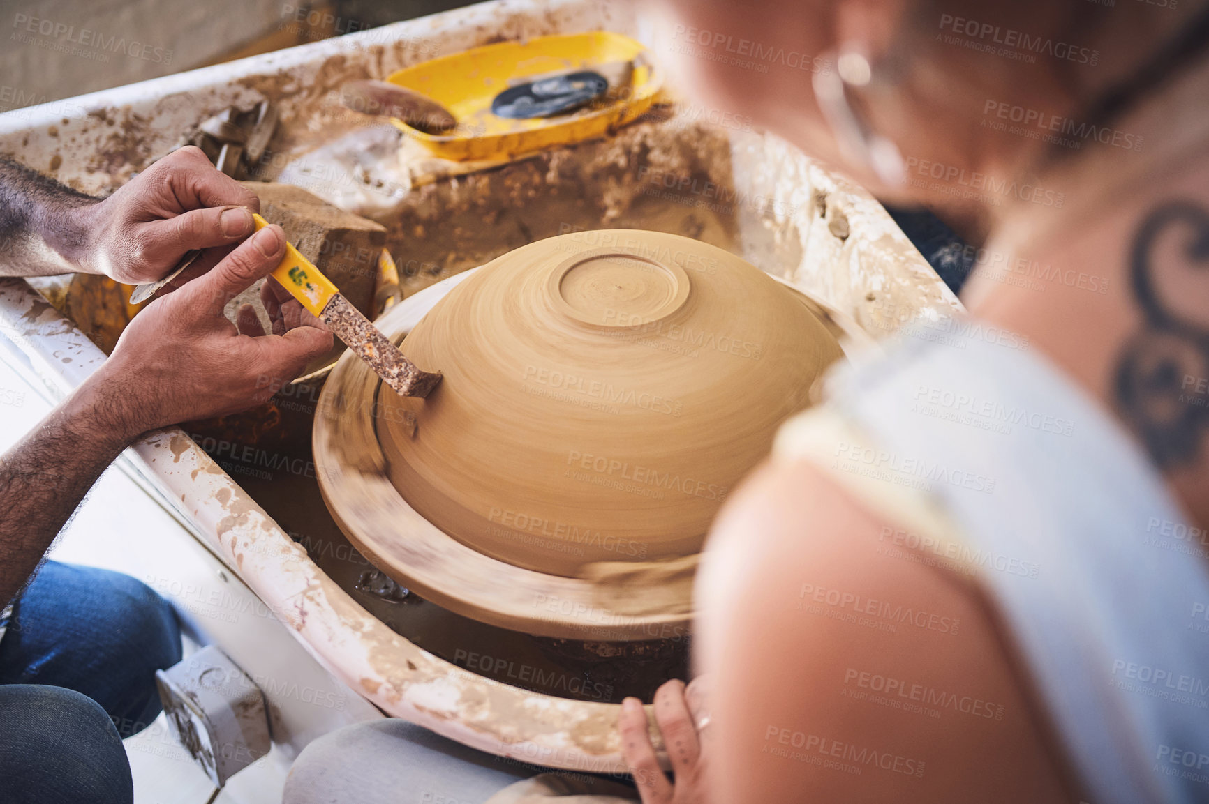Buy stock photo Shot of an unrecognisable woman working with clay in a pottery studio