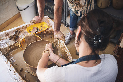 Buy stock photo Shot of an unrecognisable woman working with clay in a pottery studio