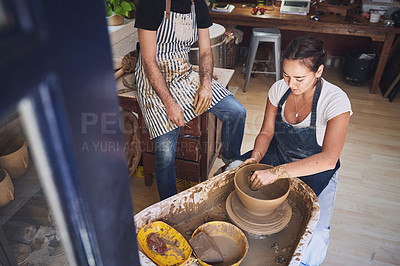 Buy stock photo Shot of woman working with clay in a pottery studio