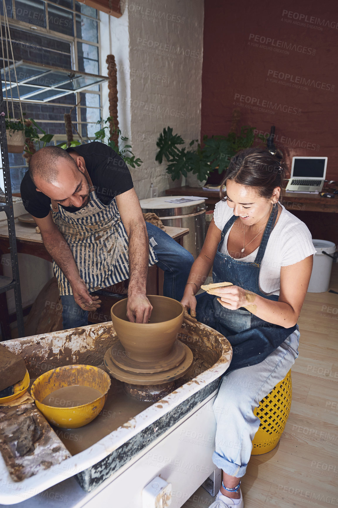Buy stock photo Pottery wheel, smile and people with clay, entrepreneur and manufacturing of art product and order. Teamwork, colleagues and creative for production in workshop, craftsmanship and process with mold