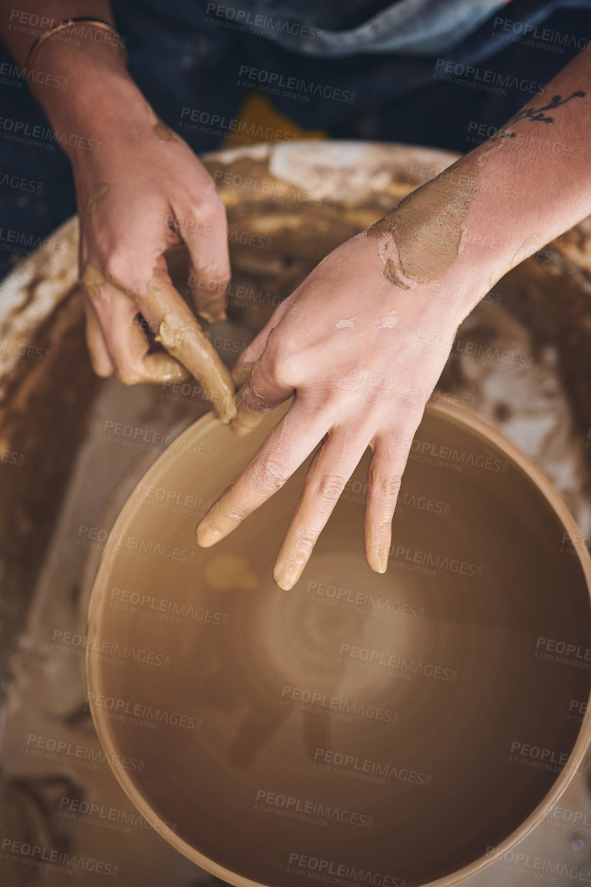 Buy stock photo Shot of an unrecognisable woman working with clay in a pottery studio