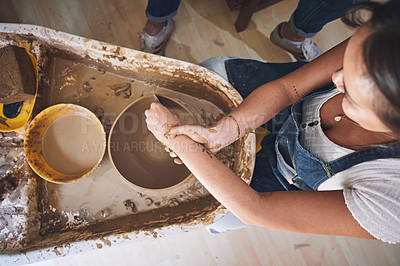 Buy stock photo Shot of a woman working with clay in a pottery studio