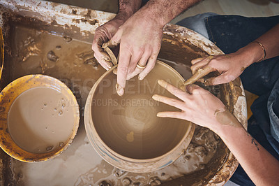 Buy stock photo Shot of an unrecognisable man and woman working with clay in a pottery studio