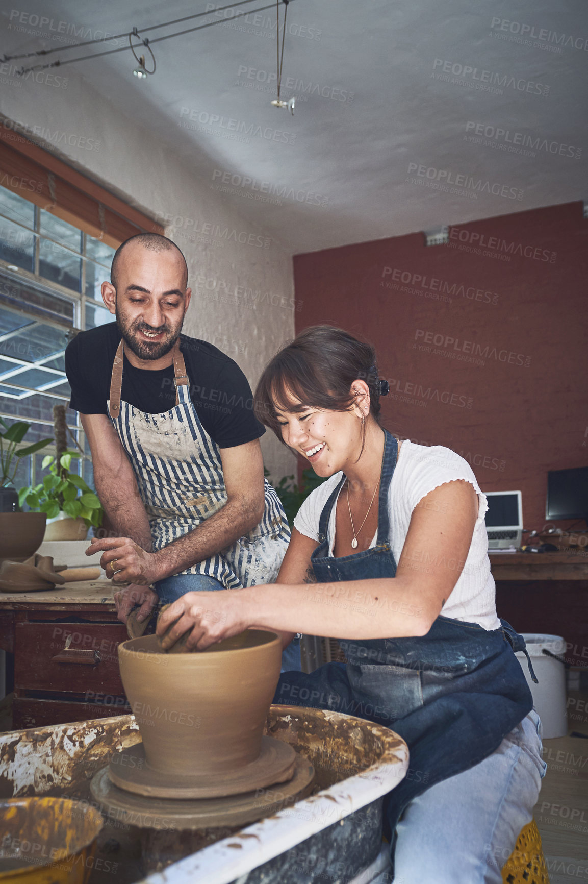 Buy stock photo Class, teacher and woman with pottery wheel, clay and talent for handmade product, learning or process. Lesson, creative and skills for production of bowl, artist or people with equipment in workshop