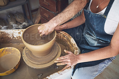 Buy stock photo Shot of an unrecognisable man and woman working with clay in a pottery studio