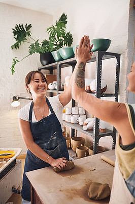 Buy stock photo Women, high five and smile with pottery in studio, learning and excited for new skill with teacher. People, mentor and support with cheers, happy and celebration for achievement with clay sculpture