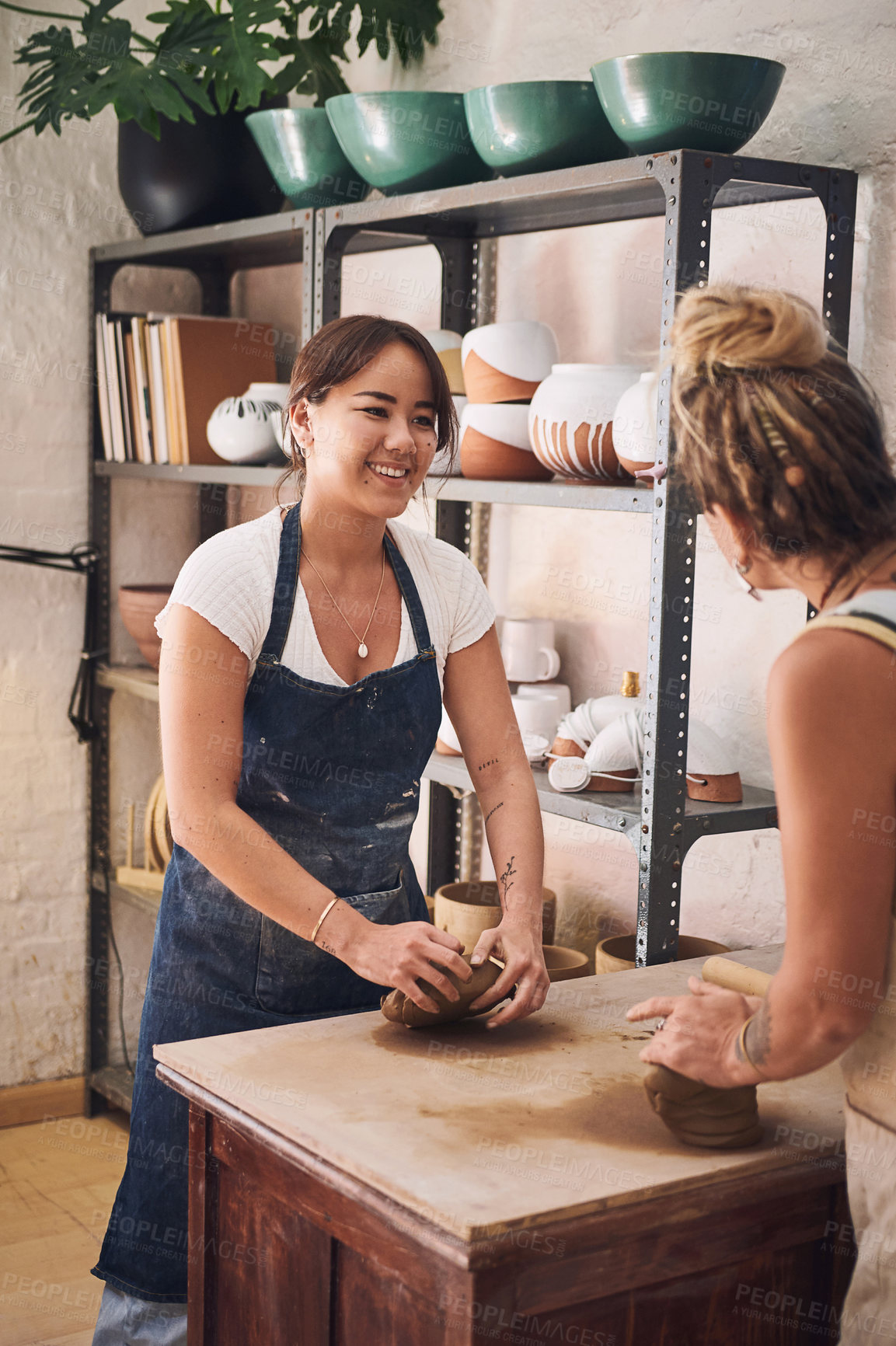 Buy stock photo Women, teaching and clay in workshop for pottery, guide and development with learning for new skill. People, mentor and talking with mold, happy and design with art, sculpture or creativity in class