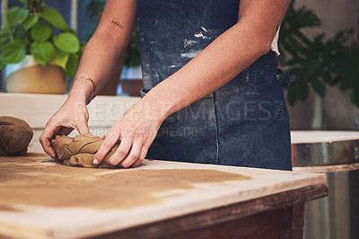 Buy stock photo Shot of an unrecognisable woman kneading clay in a pottery studio