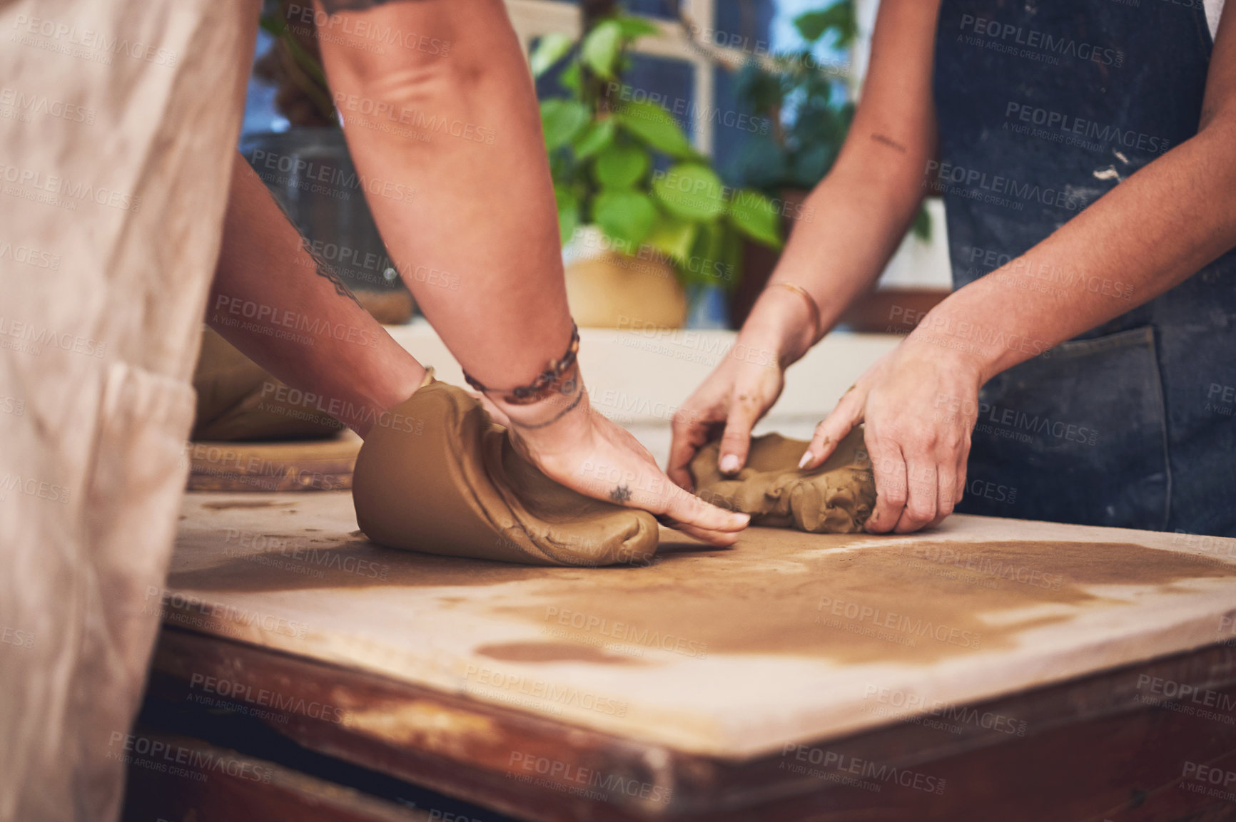 Buy stock photo Pottery, teamwork and clay with hands in workshop for partnership, small business and creative. Sculpture, production and art process with closeup of people for gallery, ceramic and talent together